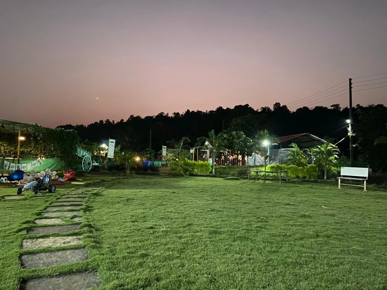 Raigad Agro Park lawn at dusk with lights on