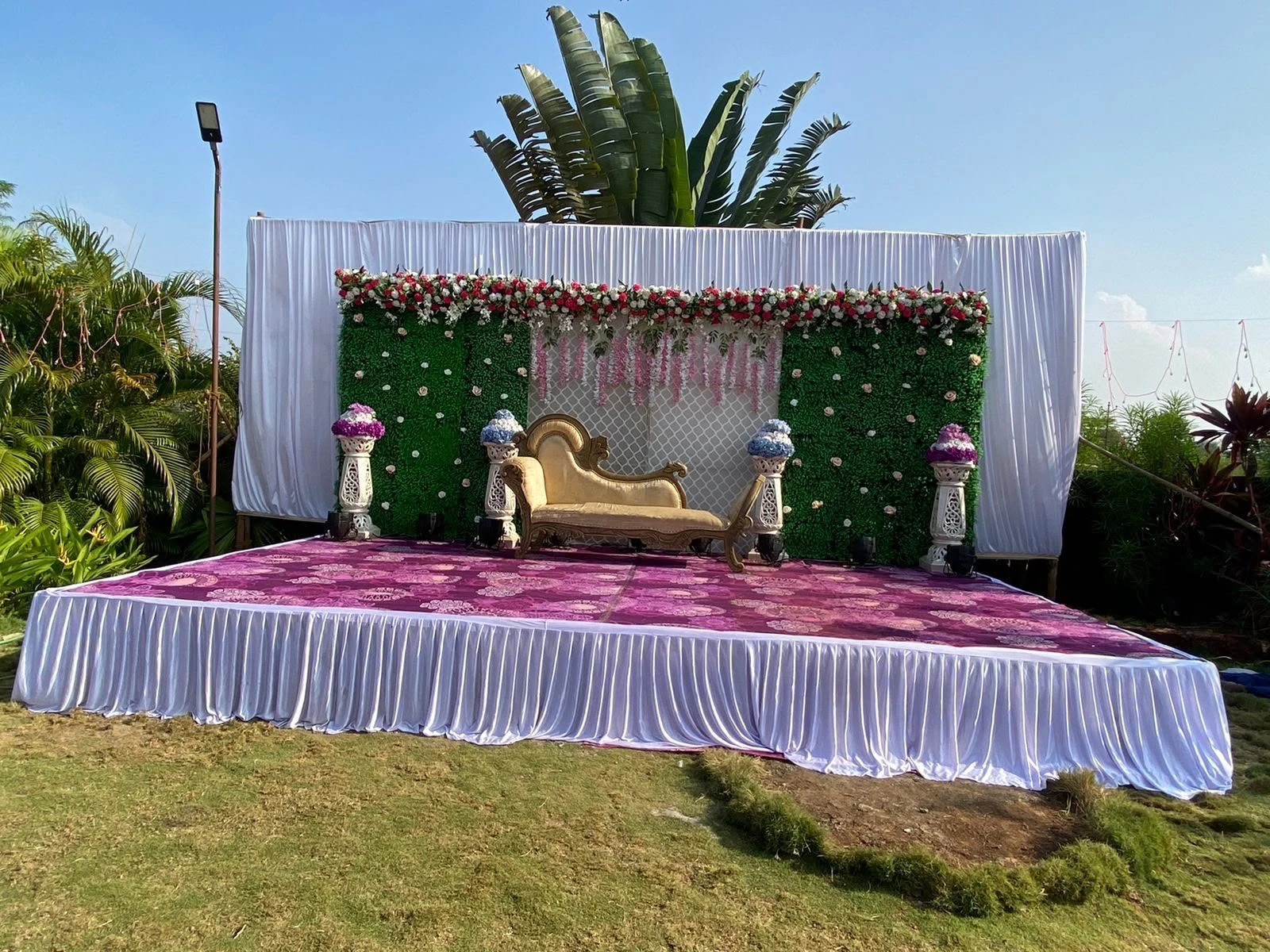 A floral stage on the lawn at Raigad Agro Park